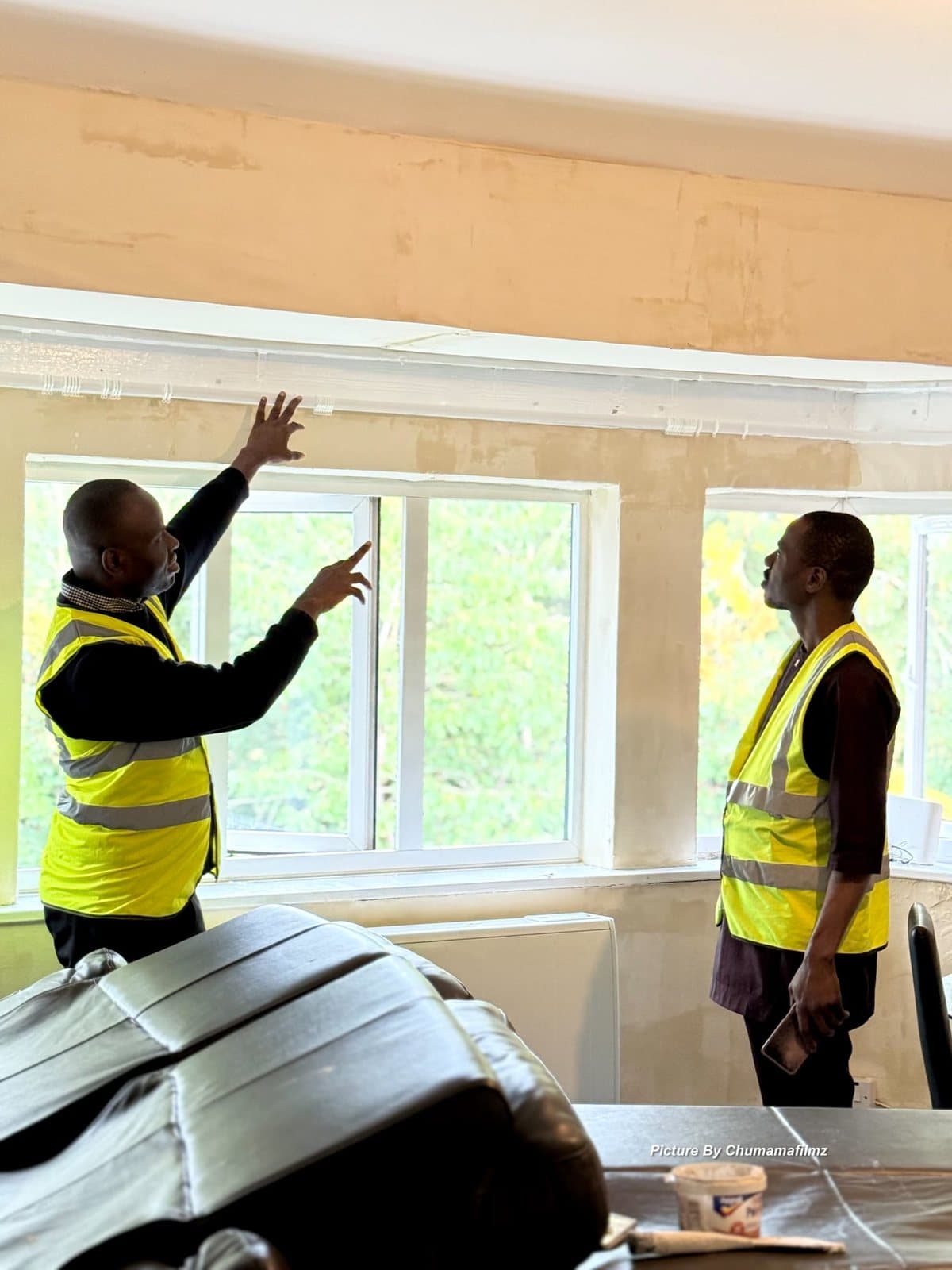 Peeman team members inspecting ceiling and window works on site